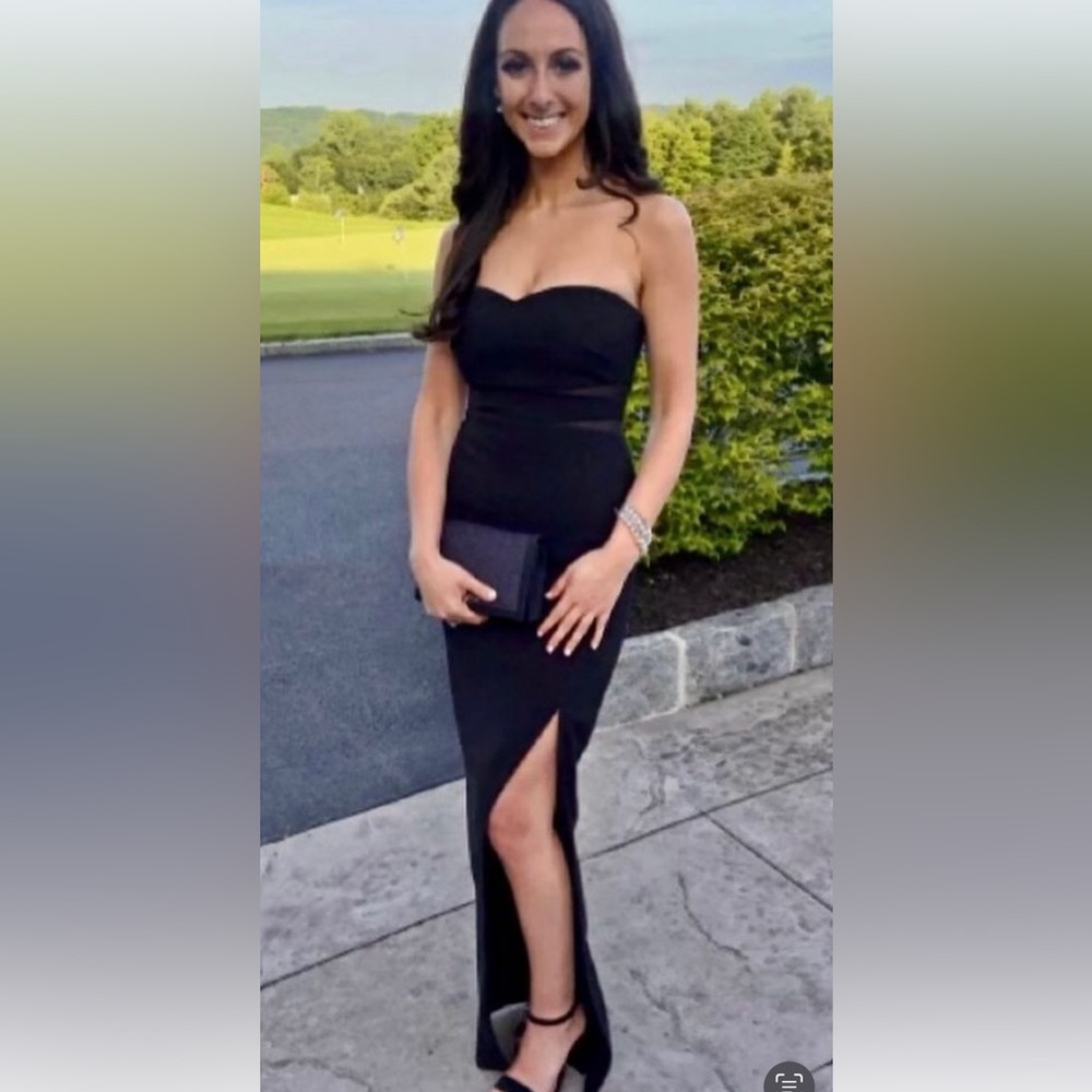 Likely strapless black gown. Worn once. Perfect condition